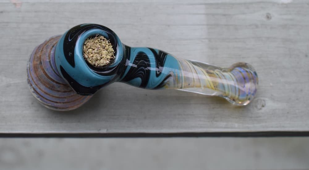 A bubbler is shown packed with cannabis.