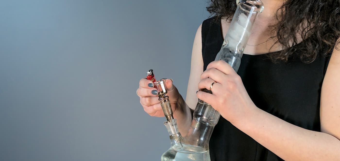 A woman is smoking a water pipe.